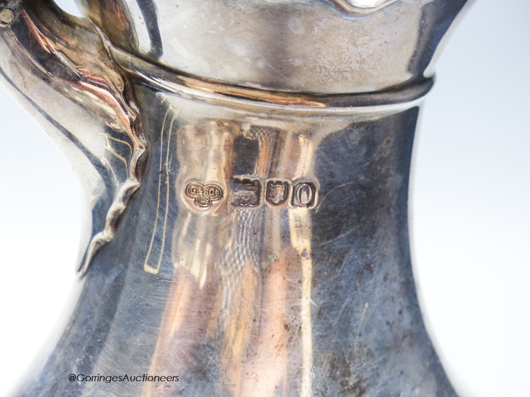 An Edwardian silver hot water pot, Goldsmiths & Silversmiths Co Ltd, London, 1909, gross 20oz.